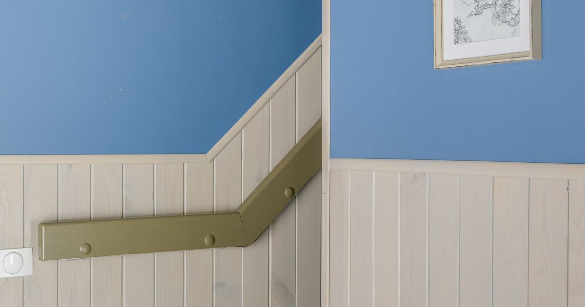 Stairs against a blue wall A staircase with white panelling set against a blue painted wall