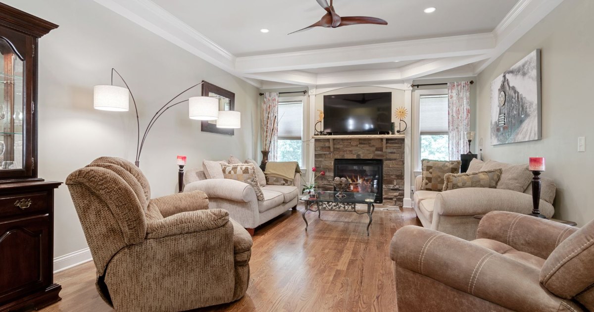 Living room with fireplace A traditional living room with sofas arranged around a fireplace