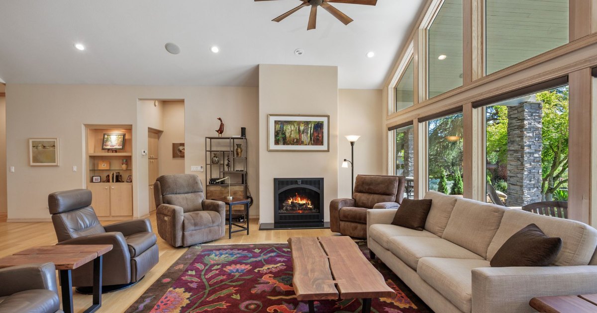 A bright open plan living room with sofas and rugs