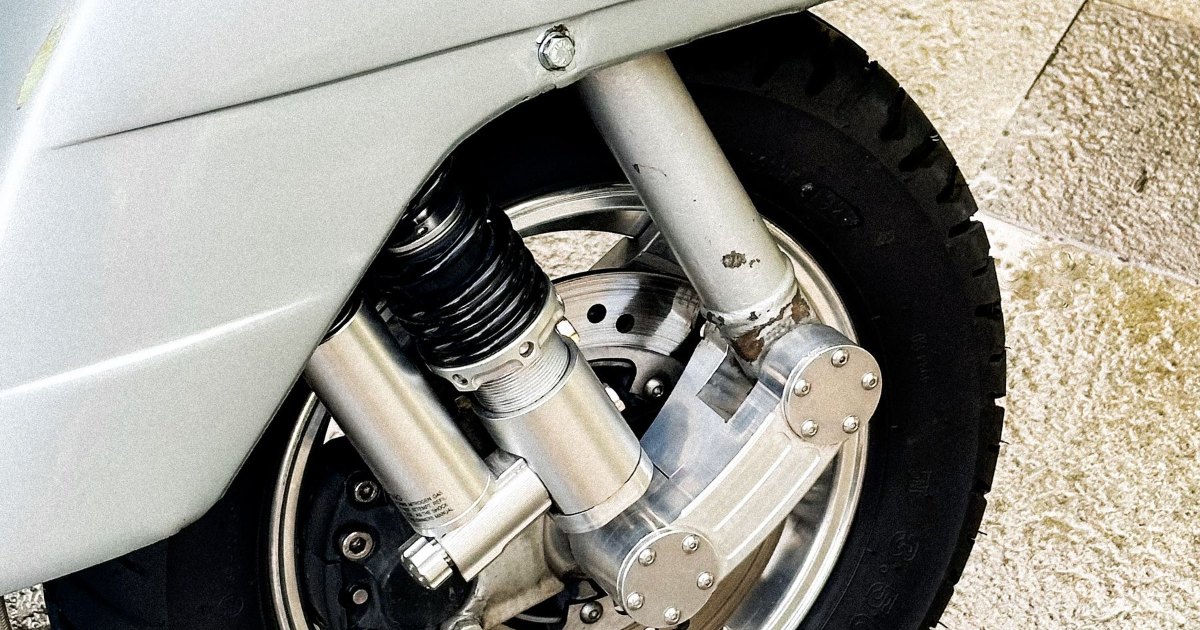 A close view of the rear wheel and motor housing of a scooter