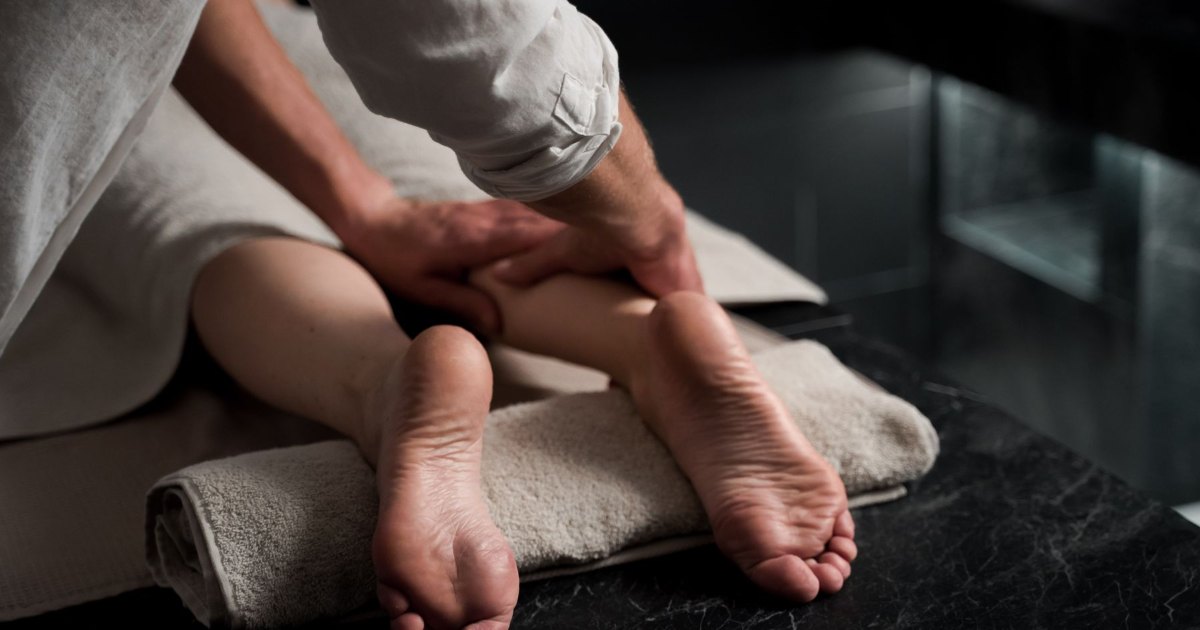 A close view of a leg being massaged during treatment