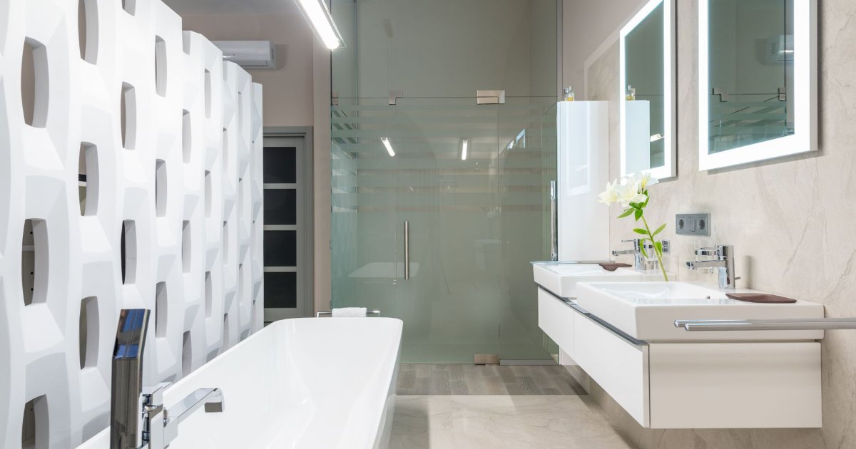 A modern bathroom with a wide basin unit and a full width mirror