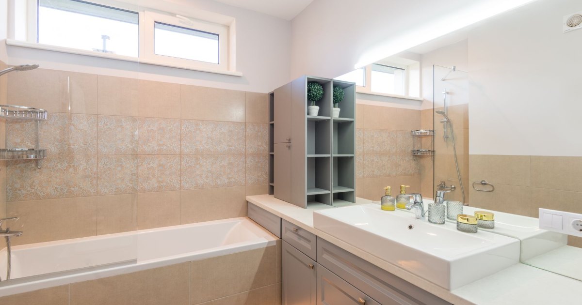 Bathroom with heated towel rail A neutral bathroom with a heated towel rail and basin