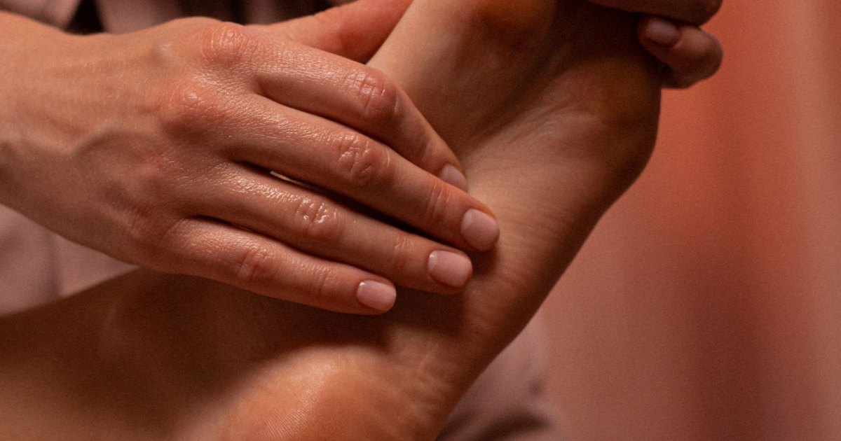 A close view of hands massaging a shoulder