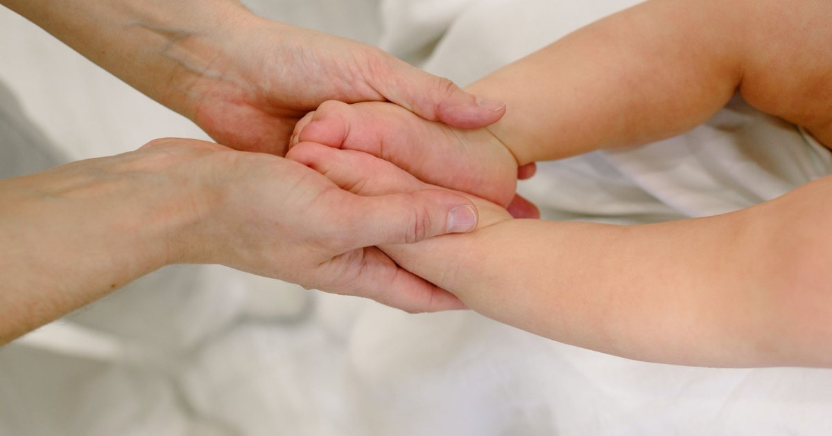 A close view of one hand massaging another