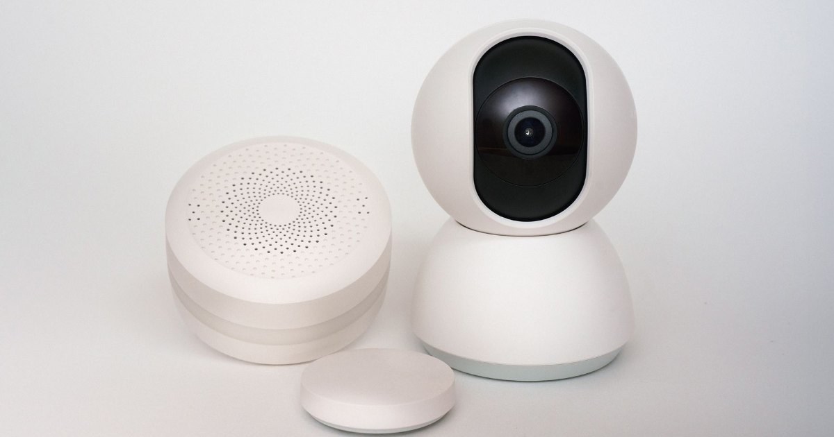 Smart home hub A smart home hub and sensor on a plain surface