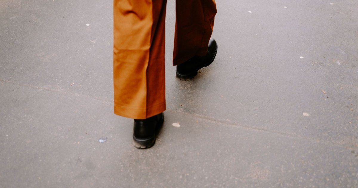 Walking on a pavement A close view of feet walking along a paved street