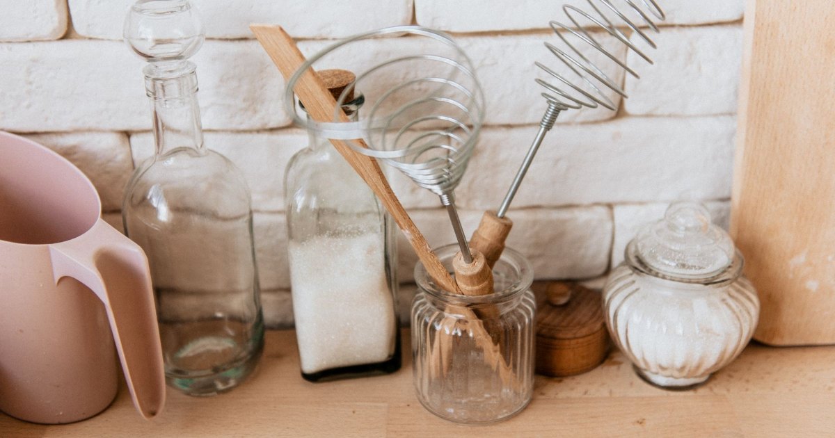 Kitchen utensils stored in jars on a worktop
