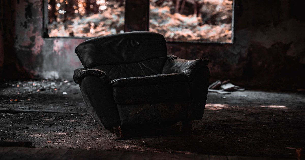 Armchair by a fire An armchair placed beside a lit fire