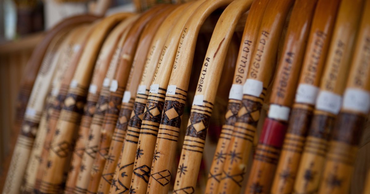 Row of wooden walking sticks A row of wooden walking sticks with curved handles lined up side by side