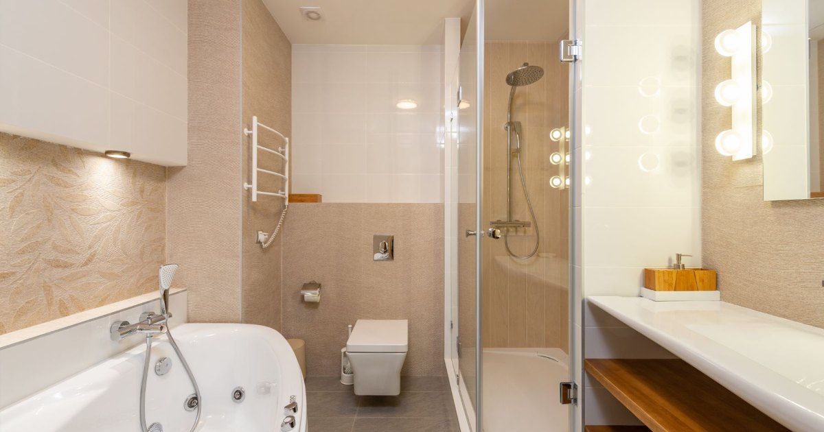 Bath in a cream tiled bathroom A bath set into cream tiling in a simple bathroom