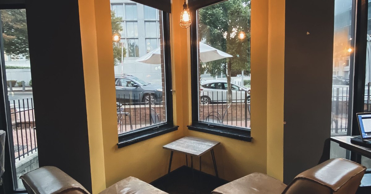 An armchair positioned beside a large window