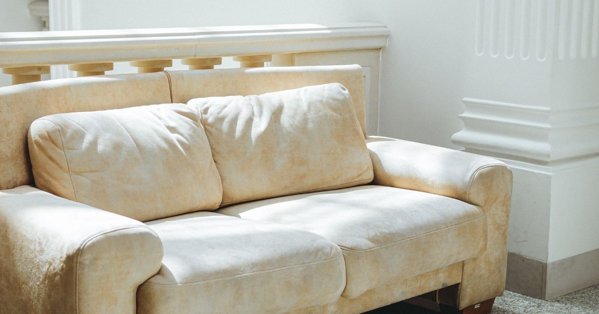 A cream fabric sofa in a bright living room