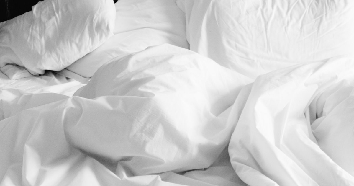 White duvet folded back A white duvet folded back across a bed