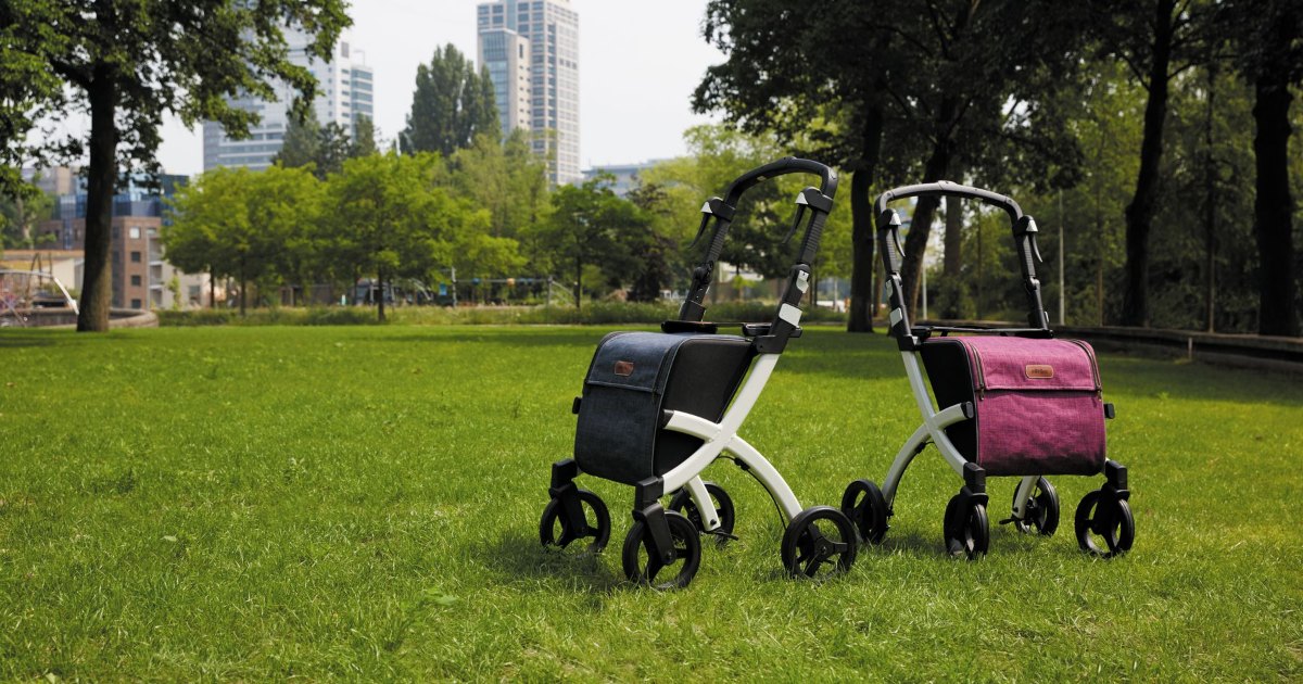 Rollator walkers on grass A pair of rollator walkers with shopping bags standing on grass in a park