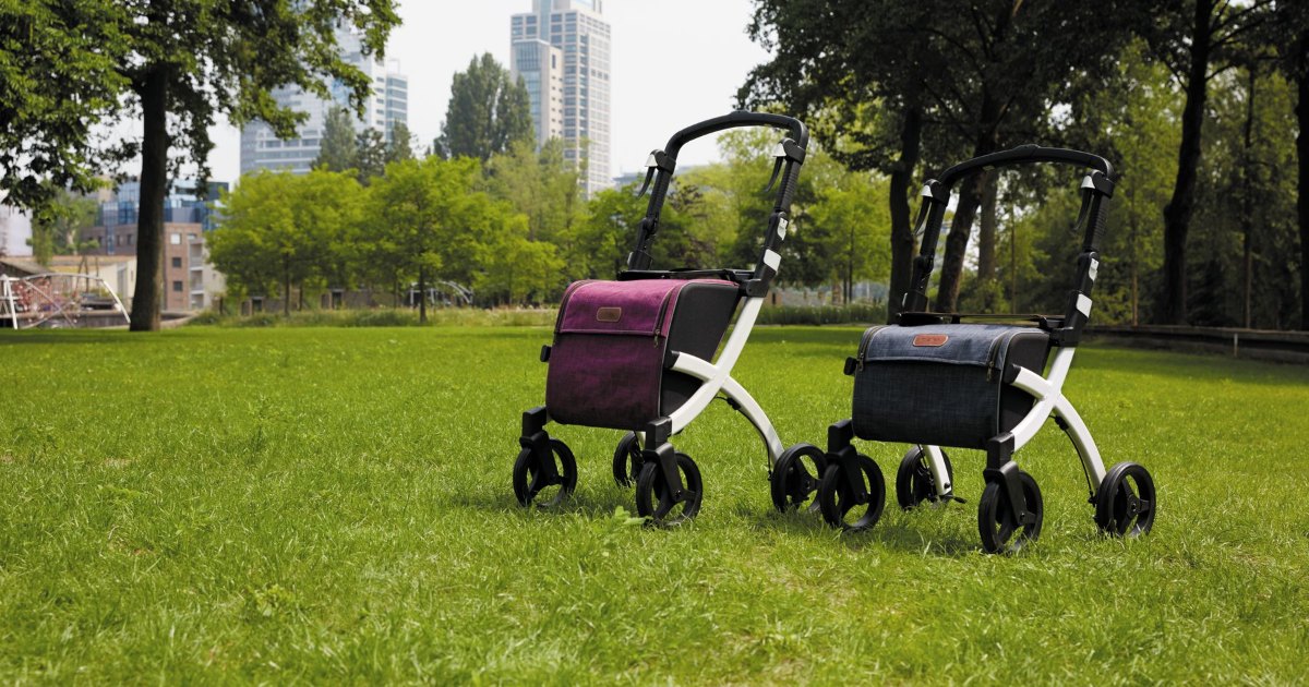 Rollators in a park Two rollator walkers standing side by side on grass in a park