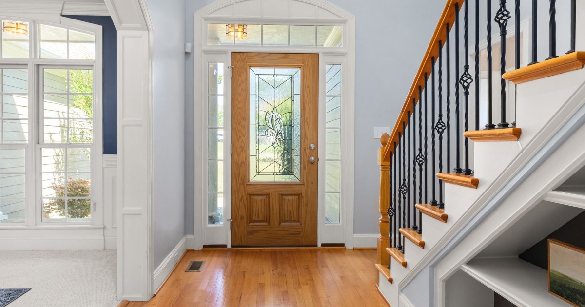 Entrance hall with staircase An entrance hall with a glazed front door and a white staircase