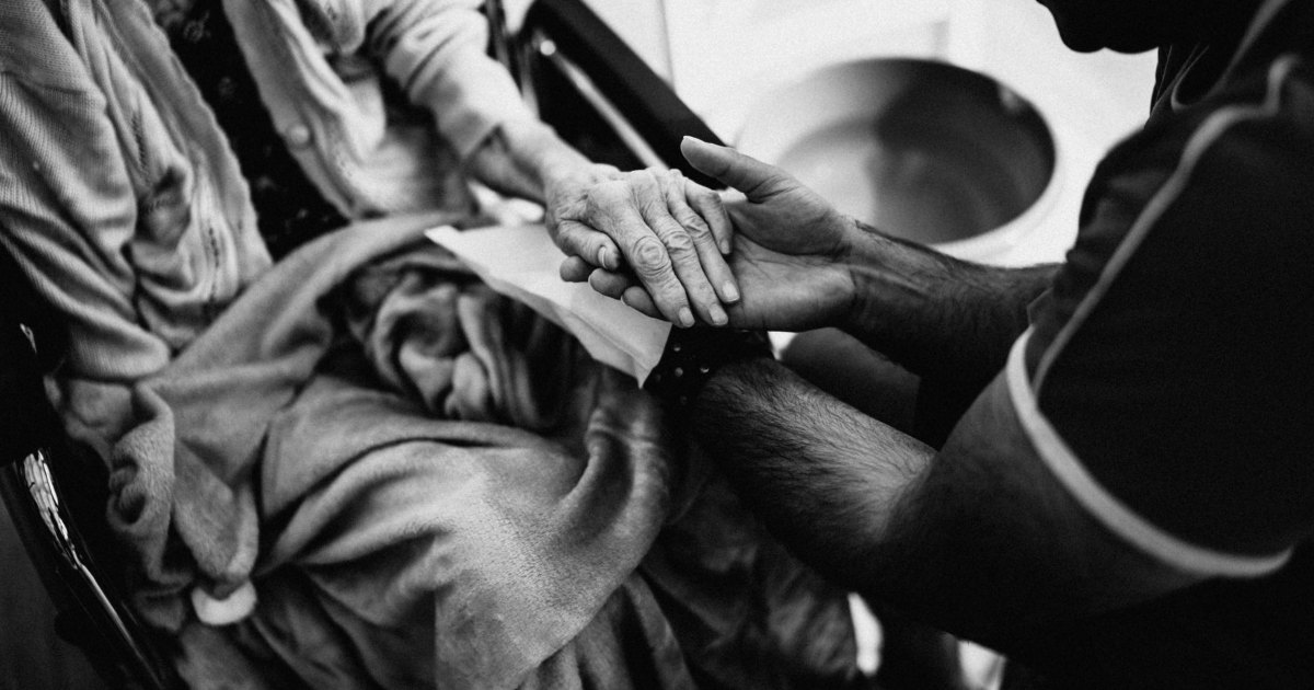 Clasped hands A black and white close view of two hands clasped together