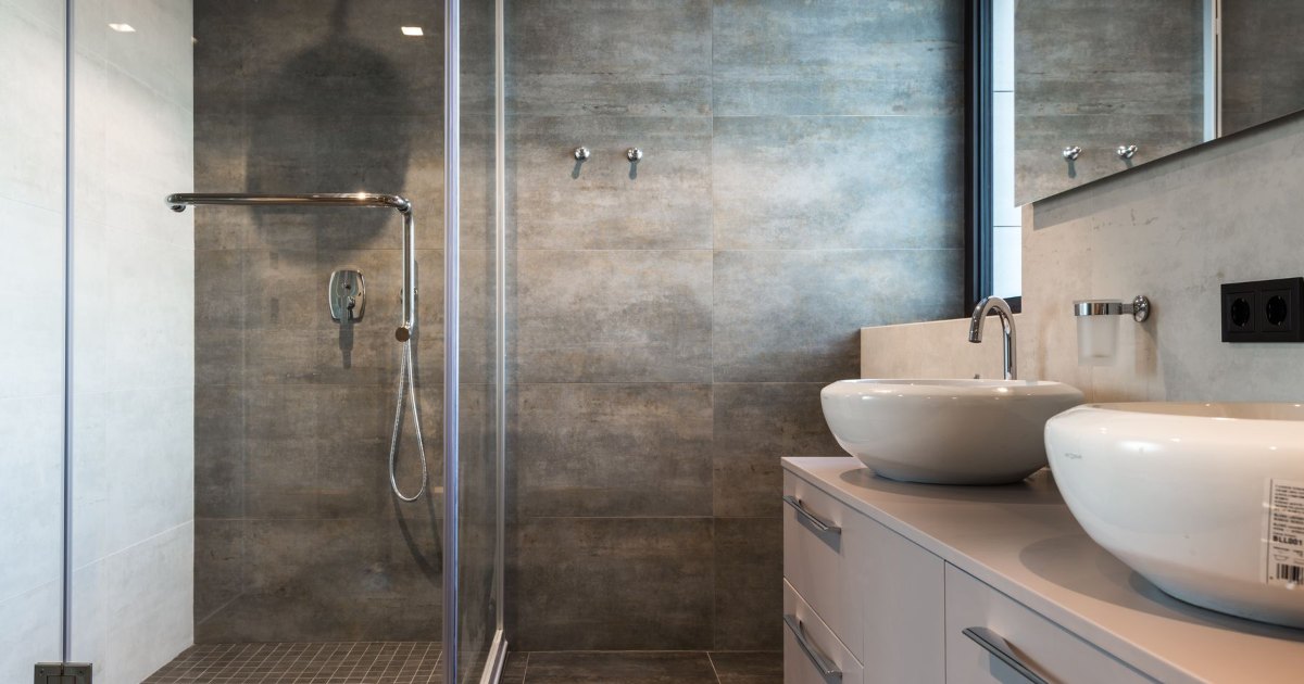 A compact bathroom with a glass shower enclosure beside the basin