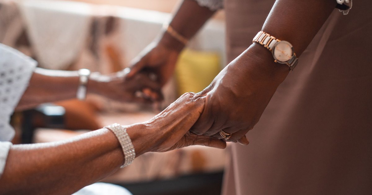 A close view of hands held together in a caring gesture