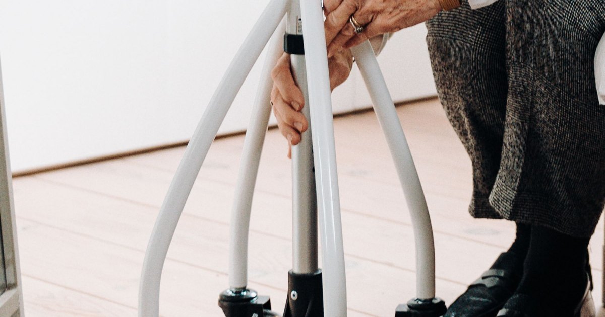Adjusting a rollator Hands adjusting the handle height of a rollator walker