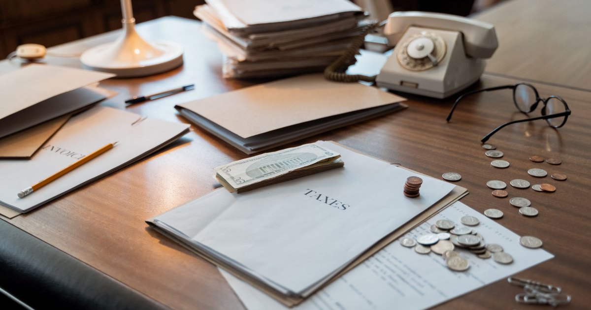 Paperwork on a desk Paperwork, a phone and a pen spread across a desk