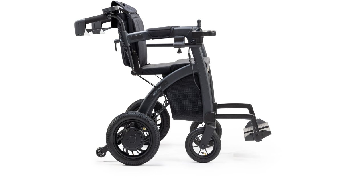A compact folding wheelchair photographed against a white background