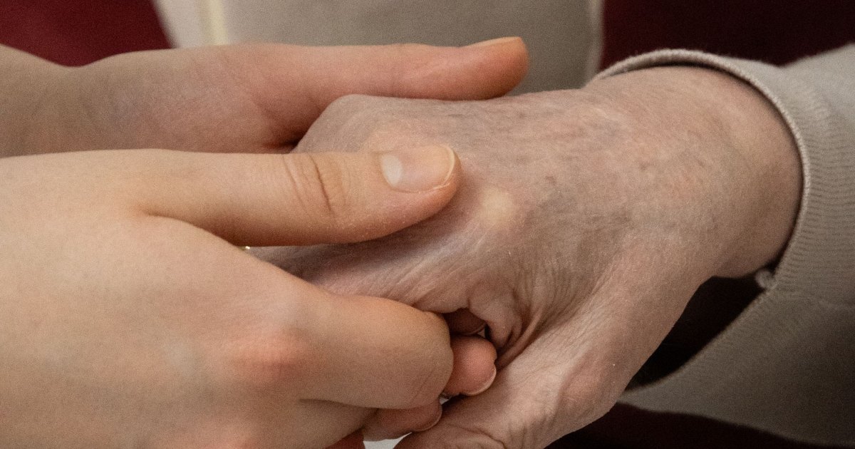 A close view of hands gently massaging another hand