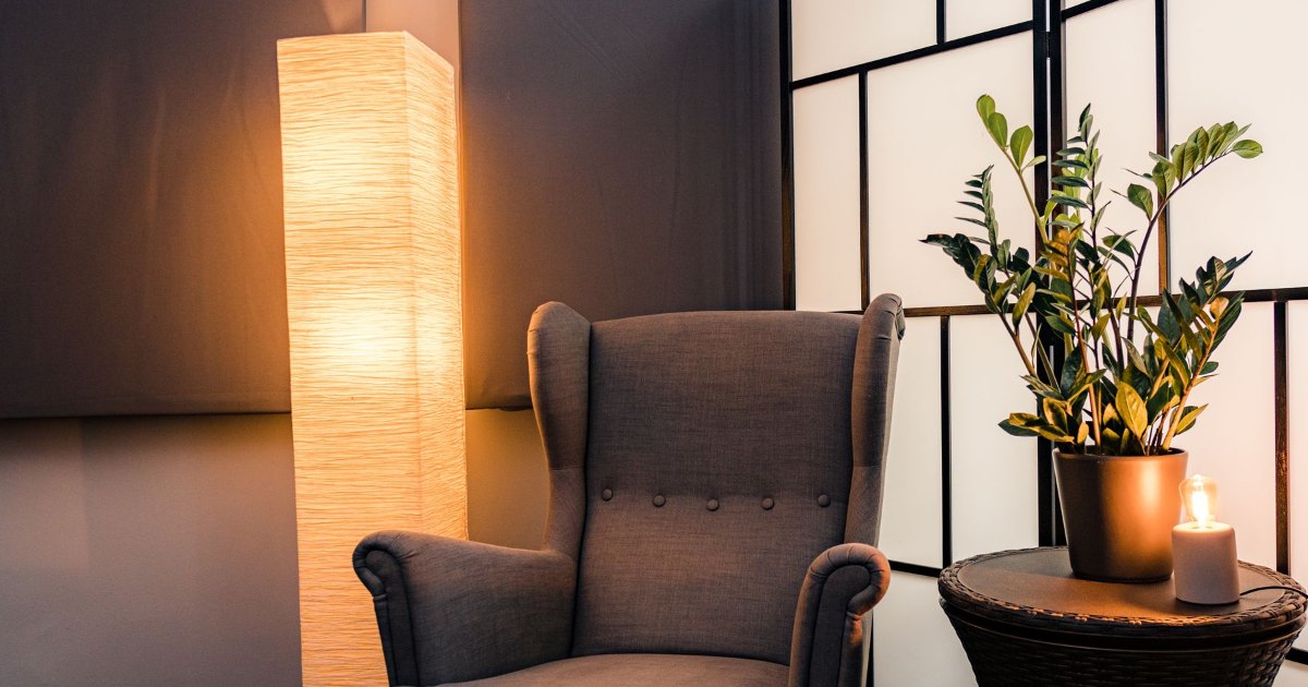 Wingback chair and floor lamp A high backed armchair beside a floor lamp in a living room