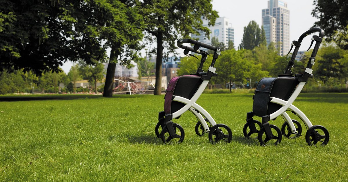 Rollator walkers with seats standing on grass on a summer day