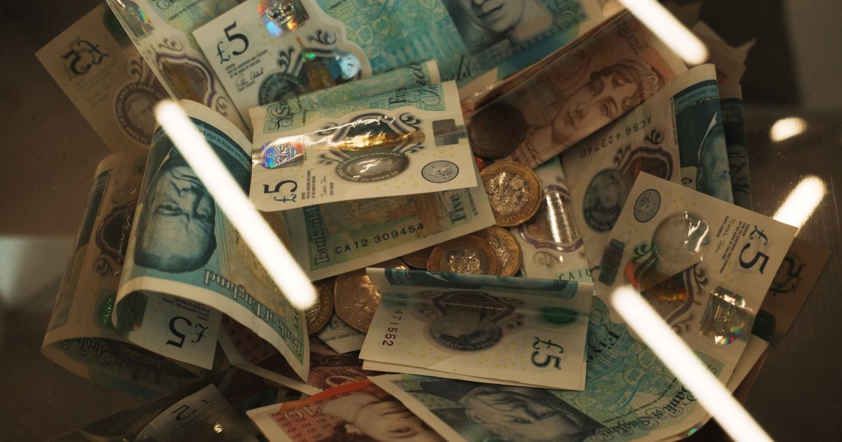 Banknotes and coins spread across a surface