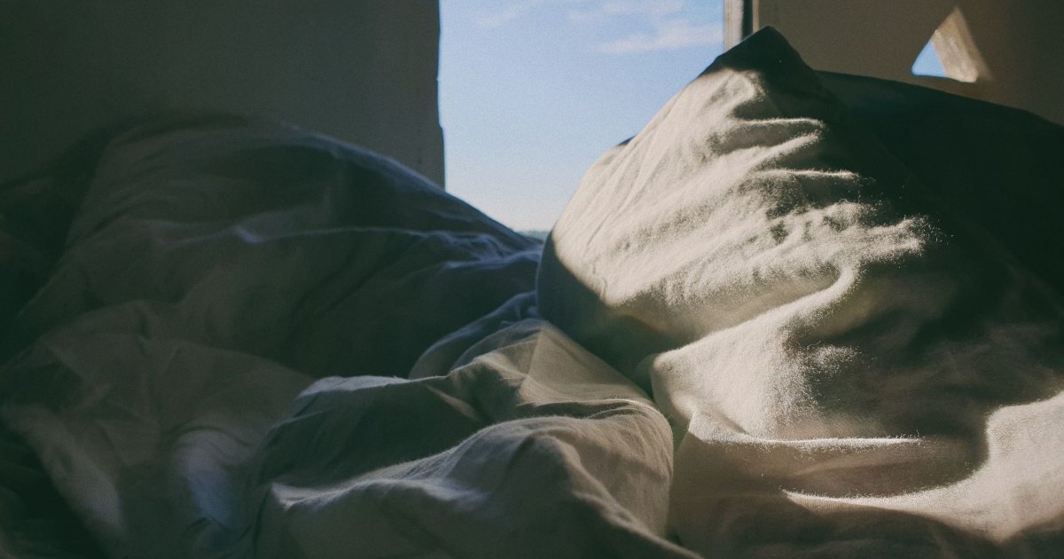 A close view of the folds in white bed linen