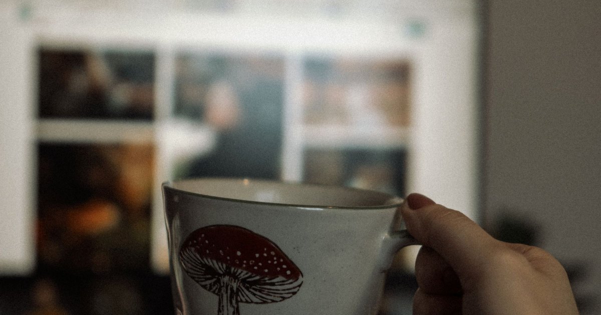 A close view of a hand holding a warm drink