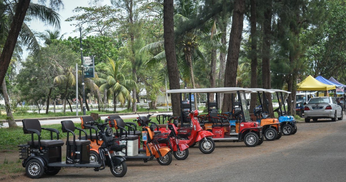 A row of mobility scooters parked together outdoors