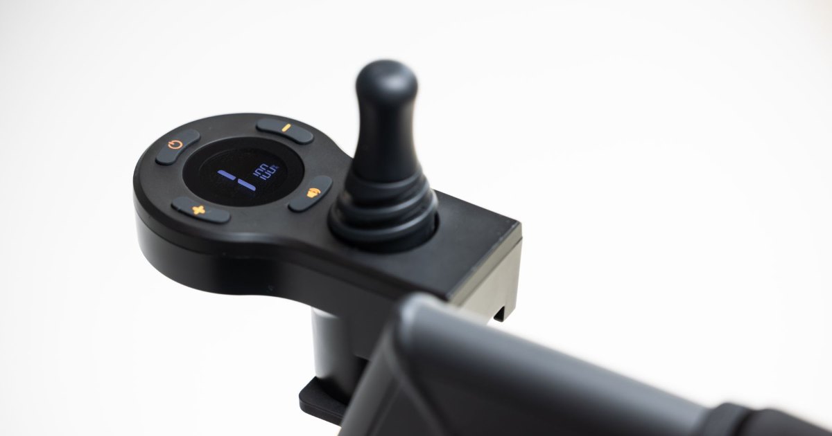 Electric wheelchair joystick controller Close view of the joystick controller on the armrest of an electric wheelchair