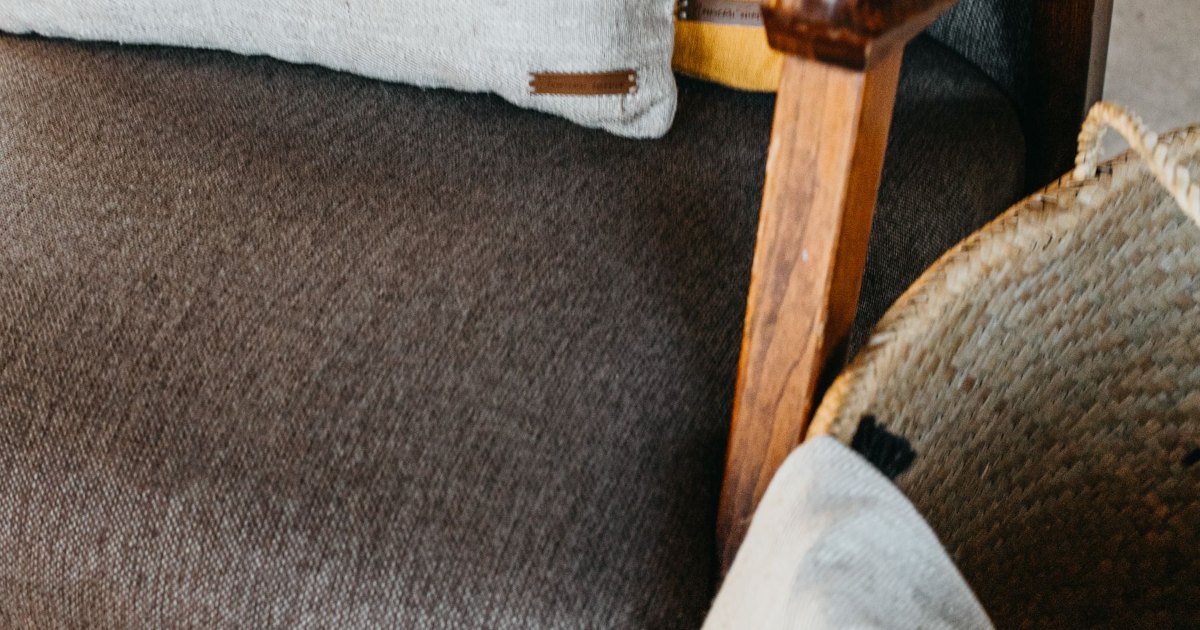 A close view of the arm of an upholstered chair
