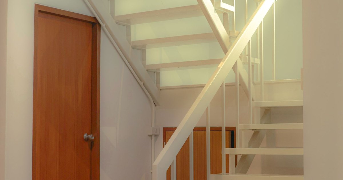 A staircase viewed through an open doorway in a home