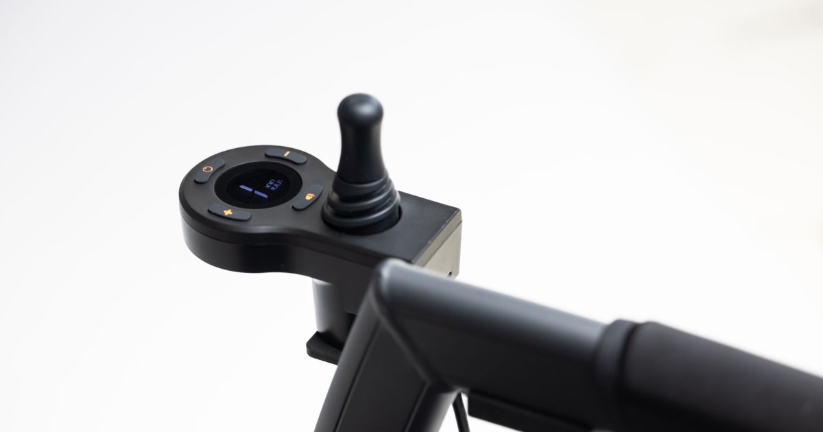 The joystick control of a modern modular motorised wheelchair on a white background