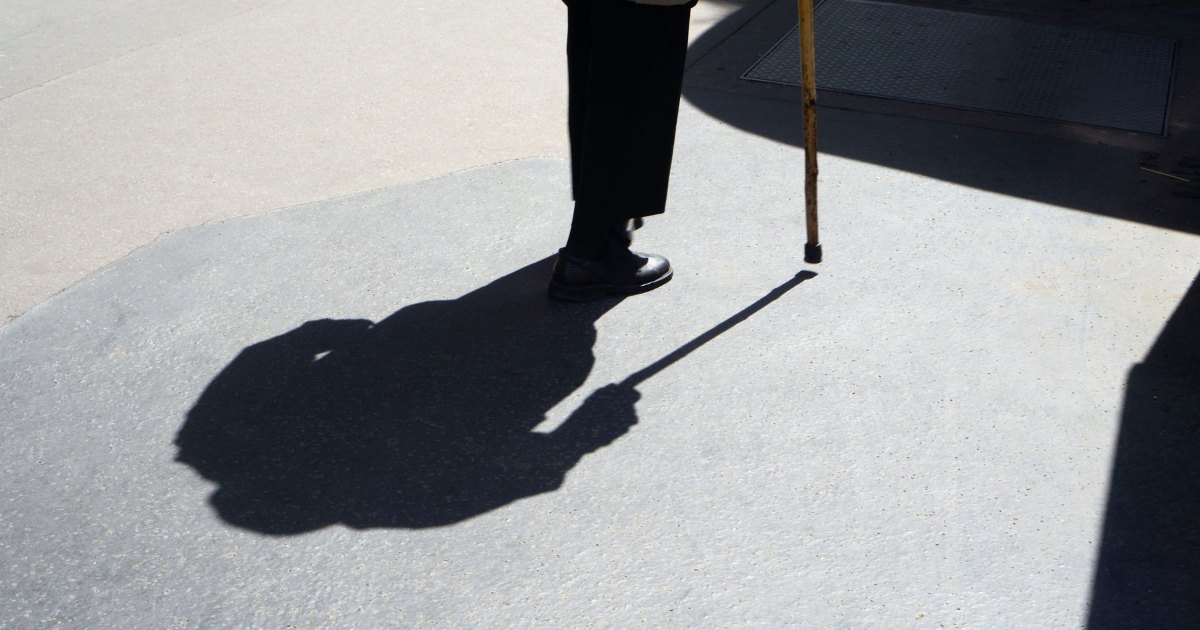 Shadow of a walking stick The long shadow of a person walking with a stick cast across a pavement