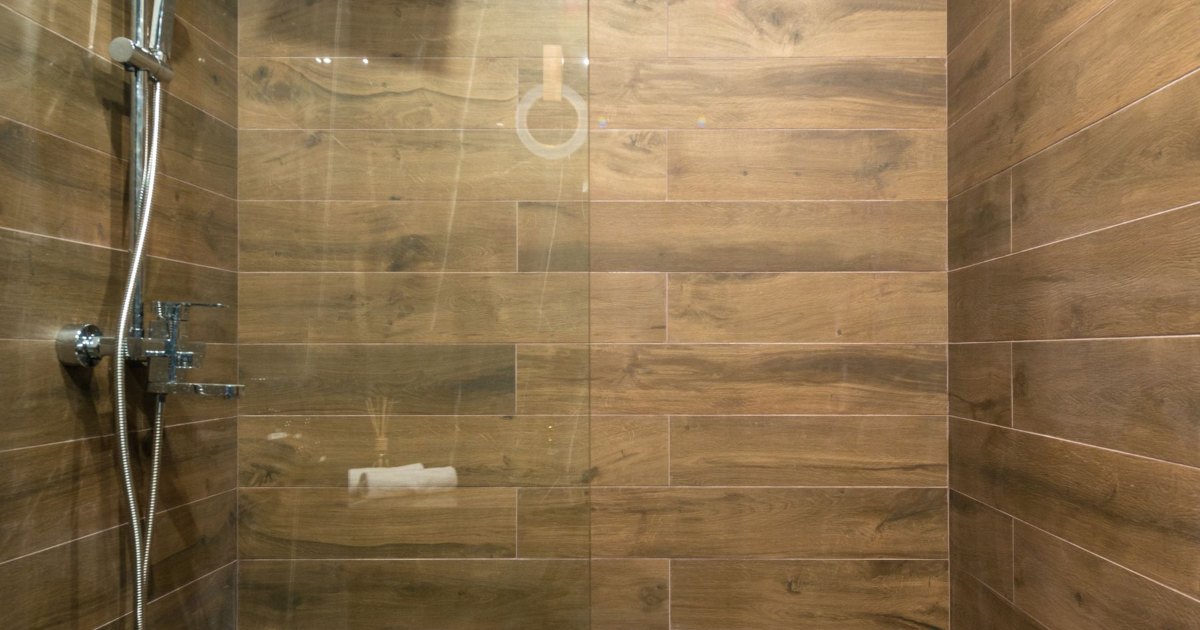 A shower area finished in warm wood effect tiling
