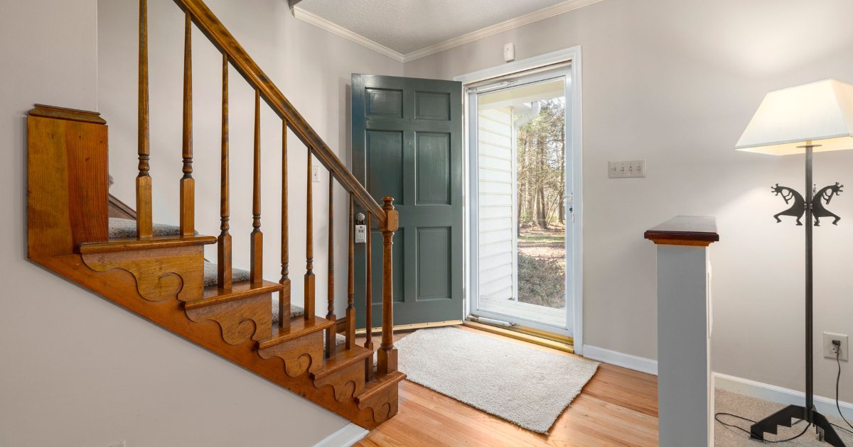 Wooden staircase by the front door A wooden staircase beside the front door in a home entrance
