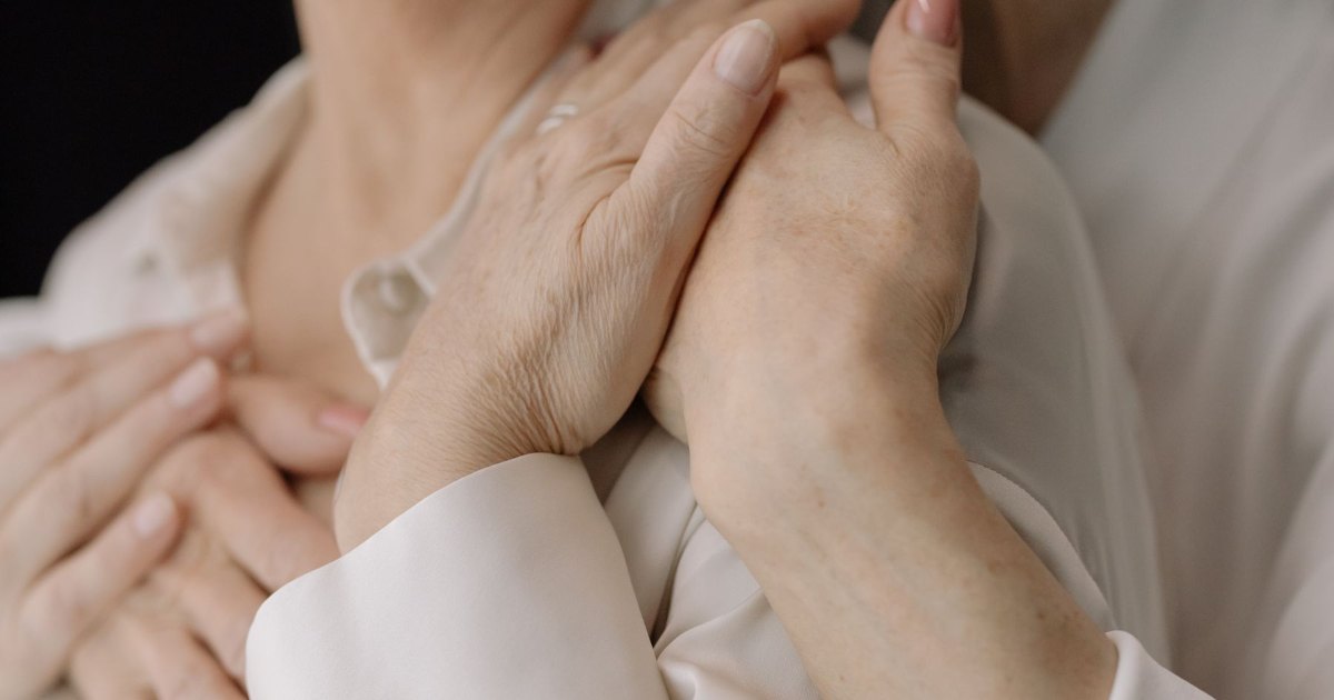 Hands and feet being cared for A close view of hands supporting a person's feet
