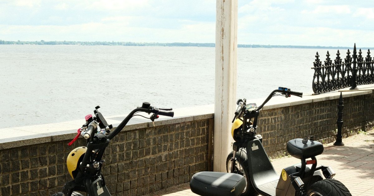 Scooters parked on a promenade A line of scooters parked along a seafront promenade