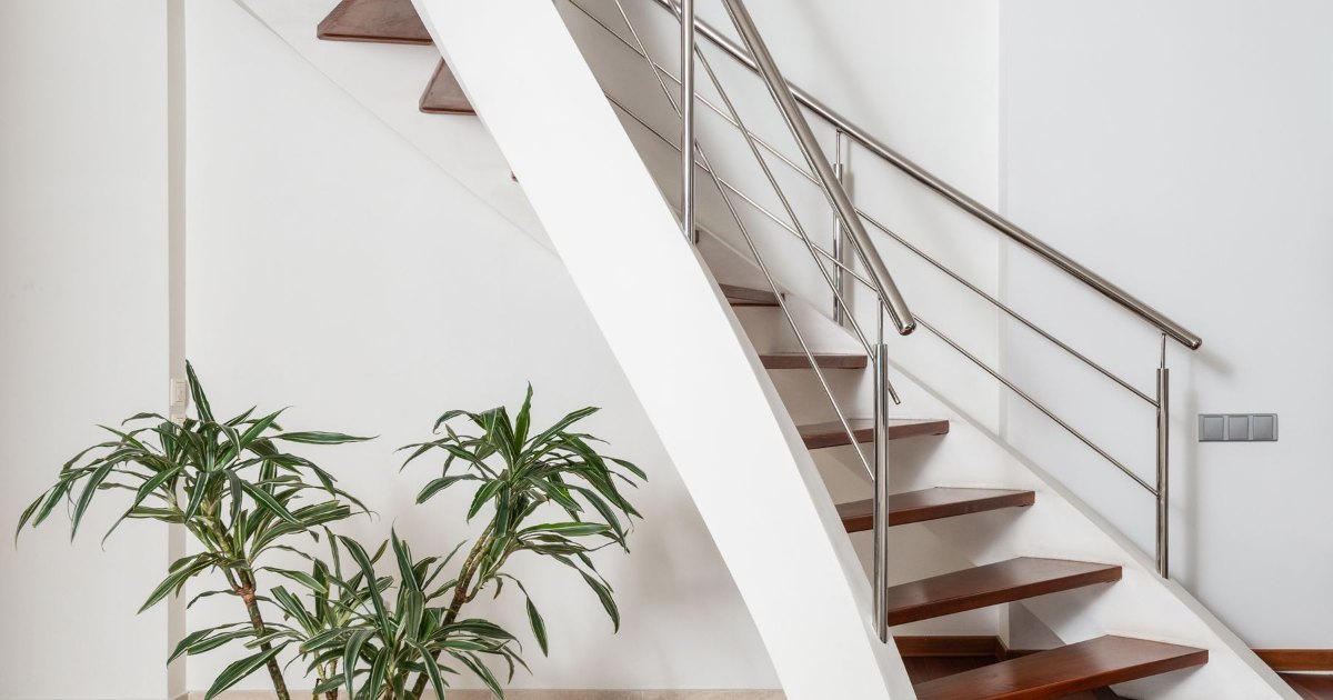 Modern stairs with metal railings A contemporary wooden staircase with slim metal railings