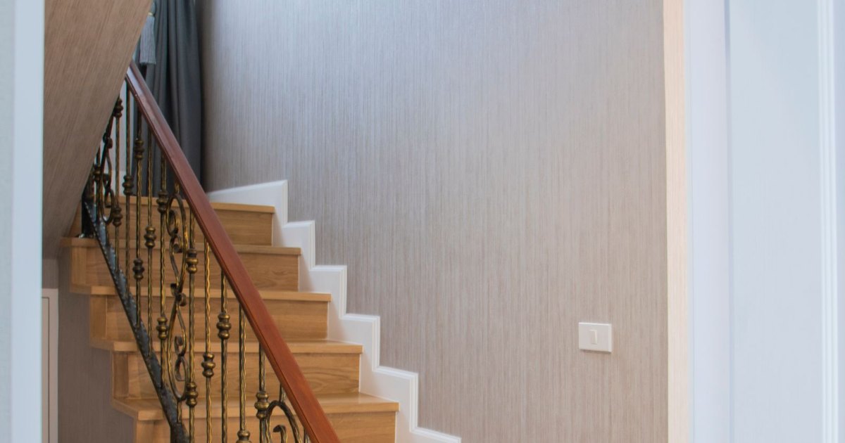Half of Britains stairlift companies no longer exist Wooden home staircase with iron railing