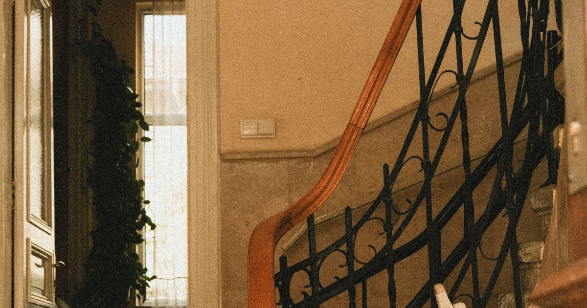 The stairlift lottery – DFG funding by council Curved staircase with a stairlift on the rail