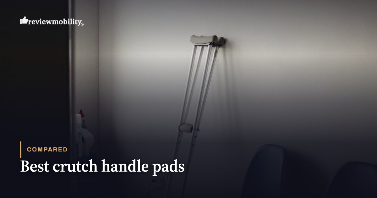 Aluminum crutch leaning against a wall in a dim room, with the Review Mobility title 'Best crutch handle pads' on screen.