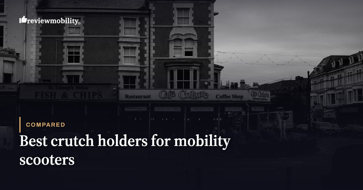 Dark street scene with row of shopfronts, including Fish & Chips and Cafe Culture, overlaid by the title: 'Best crutch holders for mobility scooters'.