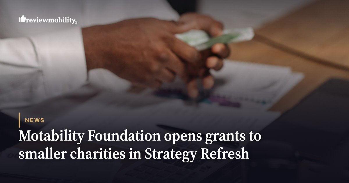 Hands counting cash over documents on a desk; Motability Foundation logo and the headline about grants to smaller charities