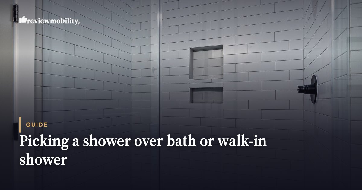 Modern walk-in shower with white subway tiles, glass door, built-in niches, and a chrome handle.